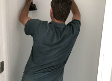 Man using level and drill